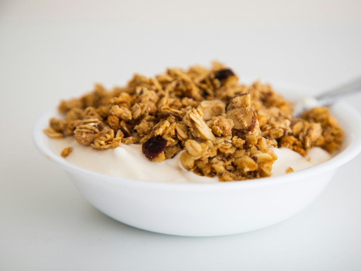 Yoğurt üzerinde granola ve kuruyemişli kahvaltı kasesi